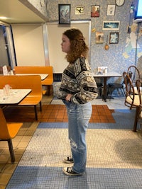 a woman standing in a diner