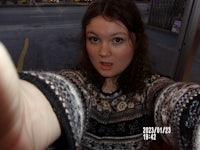 a woman wearing a sweater