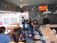 a group of people sitting at a table in a diner