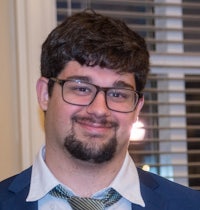 a man wearing glasses and a tie