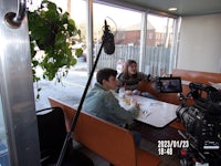 two people sitting at a table in a restaurant