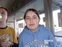 a girl wearing a blue hoodie